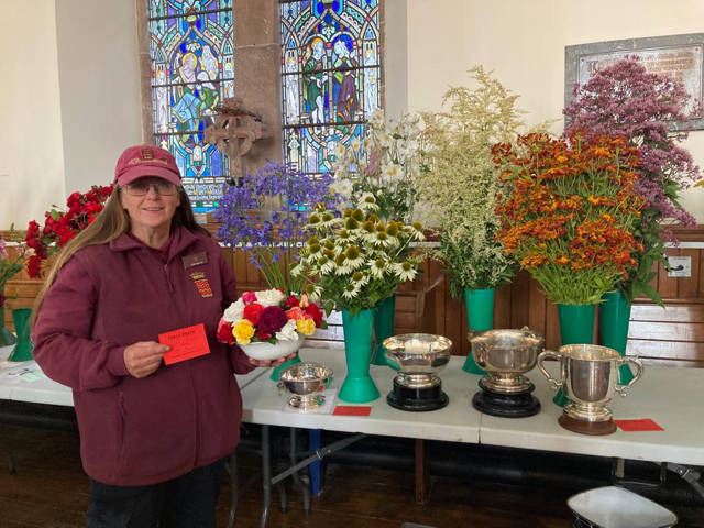 Edith Barnes showing off her silverware at the Starthearn Horticultural Society Flower Show 2023.
